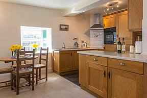 Open plan well equipped kitchen and dining area